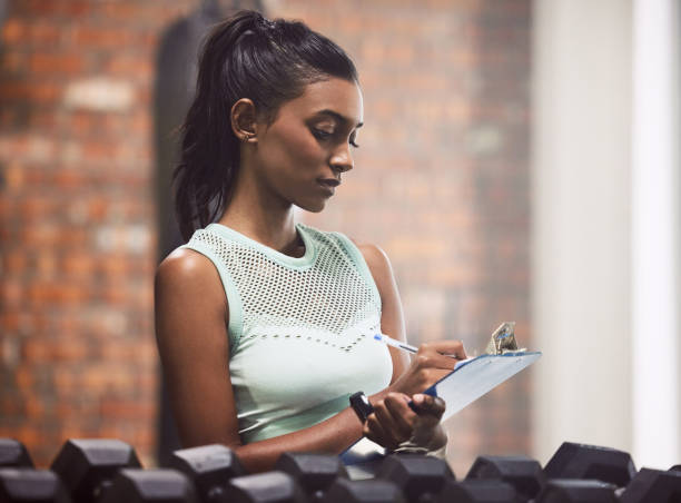 istock Shot of a young woman doing inventory while working in a gym 1336214545