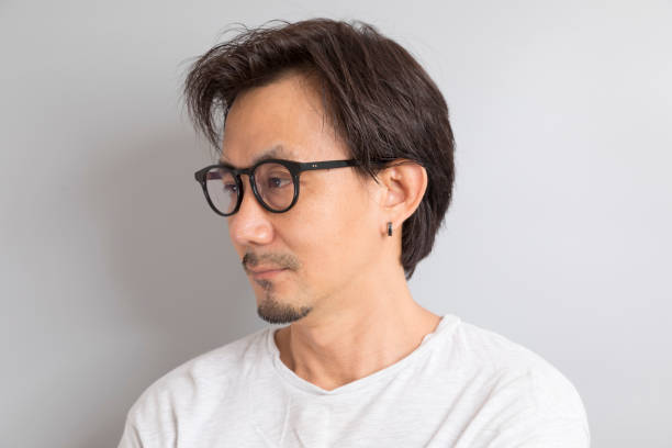 istock Asian man wearing glasses smile on grey background. 1336217419