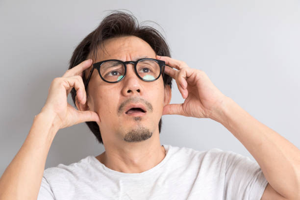 istock Asian man wearing glasses with confused and wonder expression on grey background. 1336217429