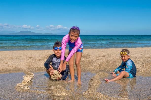 istock Three cute Eurasian kids playing on a beach in the Philippines. 1336218215