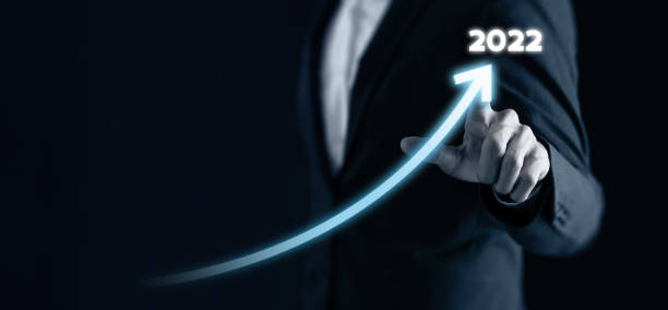istock Smart businessman pointing graph future growth plan in 2022 on dark blue background. Business development and growth concept. Artificial intelligence (AI) support to increase business performance. 1336218291