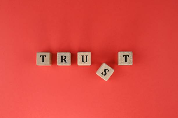 istock Wooden cubes spelling TRUST text with displaced R 1336218885