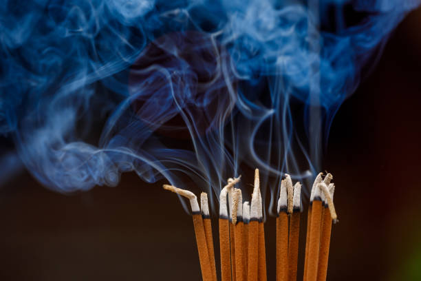 smoking incense in a temple - burning incense imagens e fotografias de stock