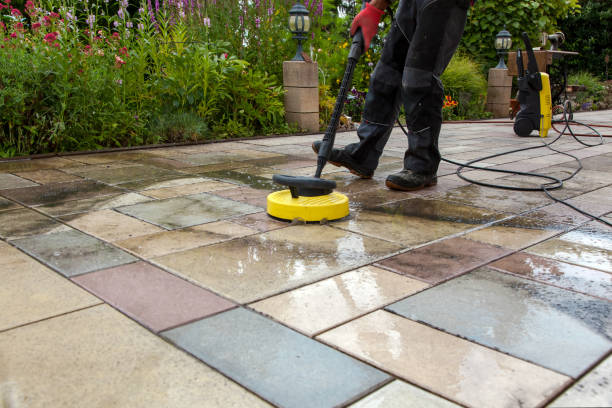 Cleaning stone slabs on patio with the high-pressure cleaner. stock photo