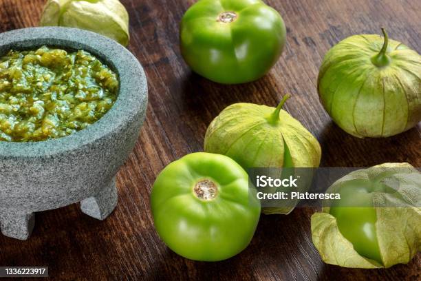 Tomatillos Green Tomatoes With Salsa Verde Green Sauce In A Molcajete Stock Photo - Download Image Now