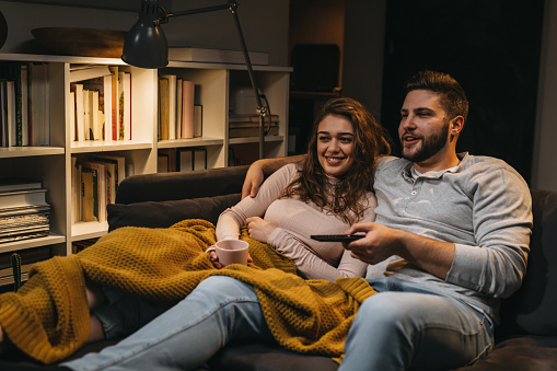 couple watching television together at home