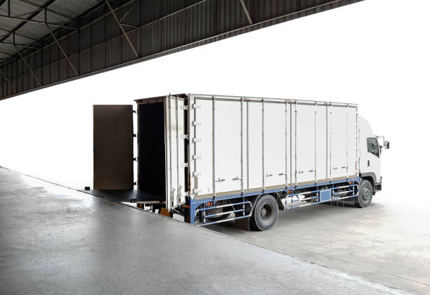 istock Cargo Truck Parked Loading Package Boxes at Dock Warehouse. Cargo Shipment. Industry Freight Truck Transportat. Shipping Warehouse Logistics. 1336228323