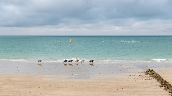 Agon-Coutainville, Normandy, France, August 18, 2021, beach in summer with sailers and riders
