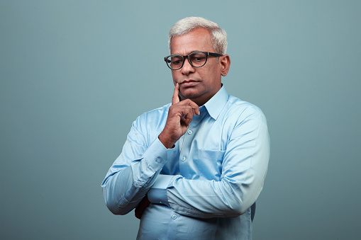 Mature man of Indian ethnicity with a  worried face