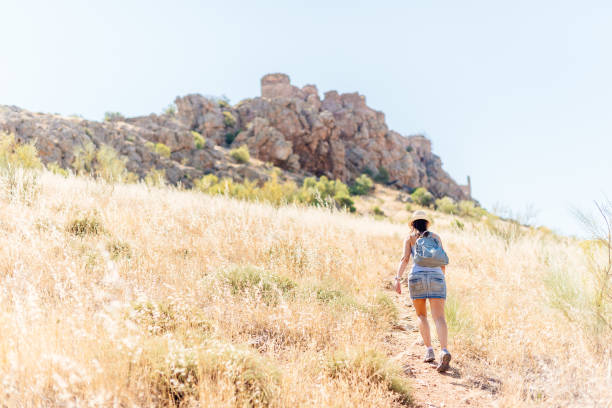 istock Woman ascending a hill towards a medieval castle. 1336231549