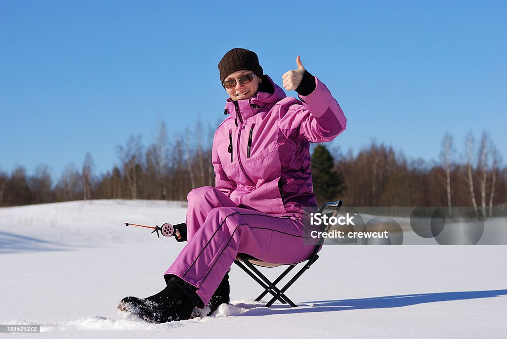 Winter hobby Young attractive girl on winter fishing Ice Fishing Stock Photo