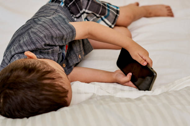 istock A little kid watching video on mobile phone 1336233846