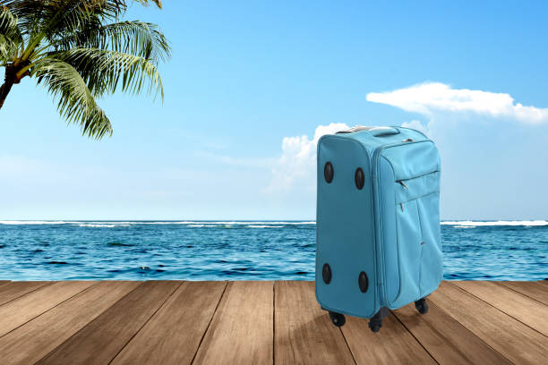 istock Blue suitcase on wooden floor 1336238366