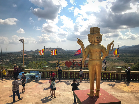 Pailin, Cambodia: January 26, 2020 - The statue of the Golden Brahma and the people taking photograph at Phnom Yat.