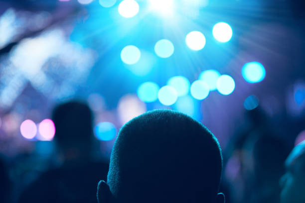 istock De-focused concert stage with laser lights and beams. 1336243716
