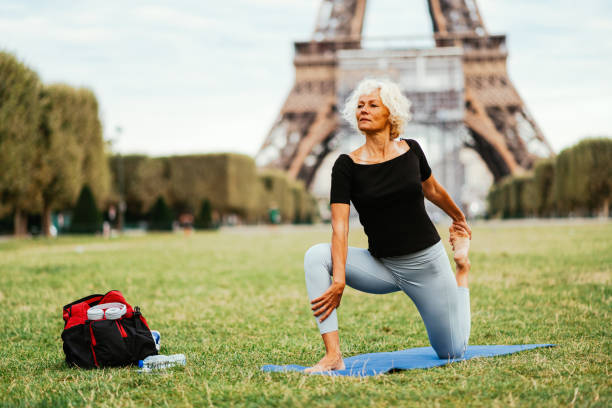 istock Active woman stretching in park near Eiffel tower in Paris 1336244048
