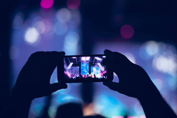 istock Person holding modern smartphone on a concert. 1336244189