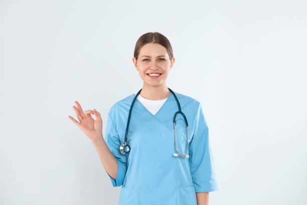 istock Young doctor with stethoscope against light background 1336244521
