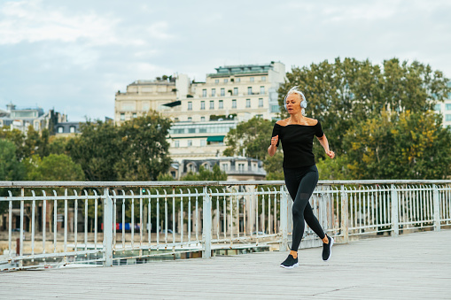 Portrait of mature woman exercising in early morning in the City of Paris