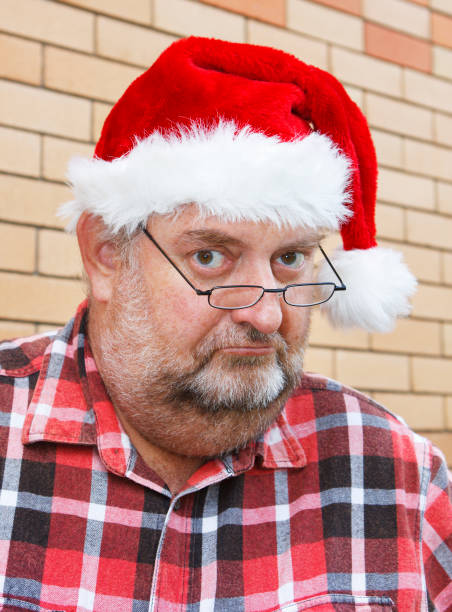 istock Grumpy mature manwith beard in Santa Hat and glasses 133624677