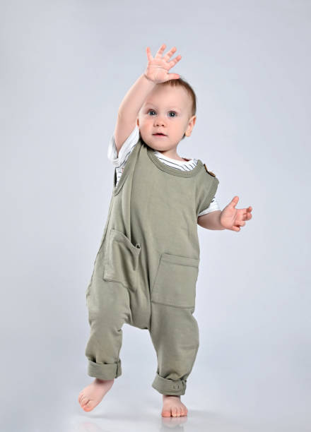 istock First steps of baby isolated on white background 1336247820