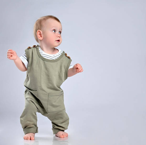 istock First steps of baby isolated on white background 1336247944