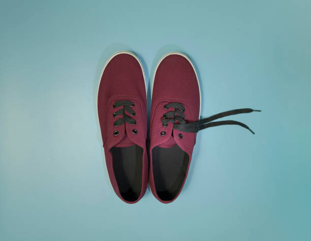 istock New sneakers. Maroon color. View from above. On blue background 1336249264