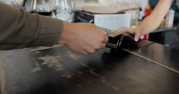 istock Close up customer pay for takeaway coffee using credit card contactless payment spending money in cafe with digital transaction service. 1336249731