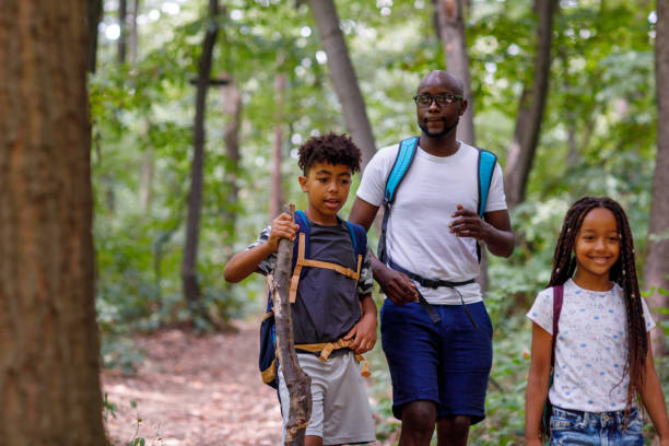 istock Father With Kids Walking In The Woods 1336249798