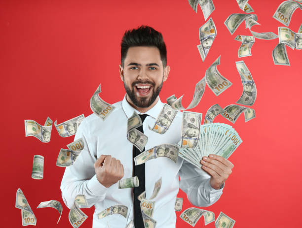 istock Happy young man with money on red background 1336249938