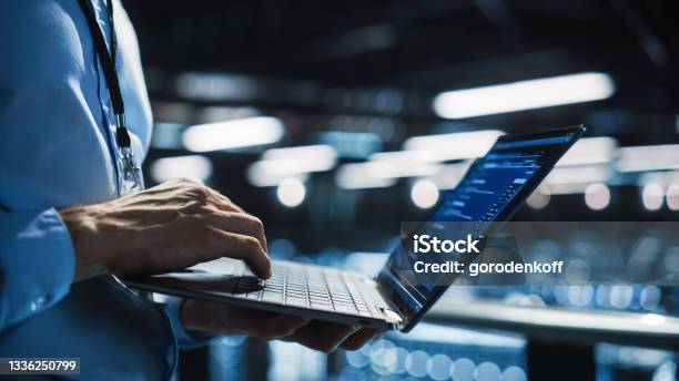 Data Center Programmer Using Digital Laptop Computer Maintenance It Specialist Cloud Computing Server Farm System Administrator Working On Cyber Security For Iaas Saas Paas Closeup Focus On Hands Stock Photo - Download Image Now
