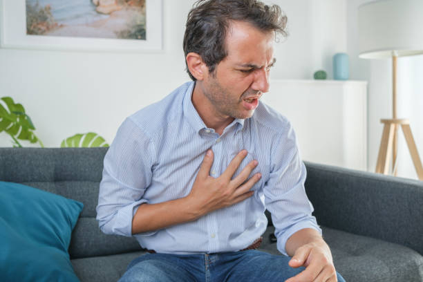istock Man suffering from gastric reflux after dinner 1336251320