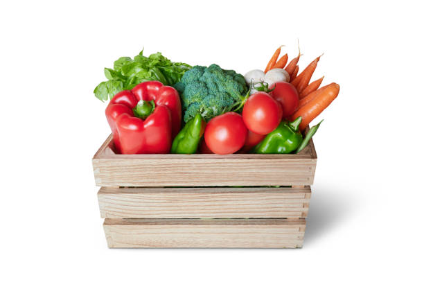 istock Fresh vegetable in wooden box isolated from the background 1336252146