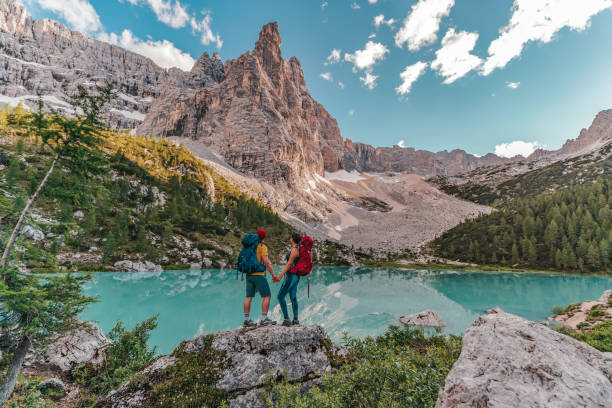 istock Couple hike along a mountain ridge in the bright sun 1336252509