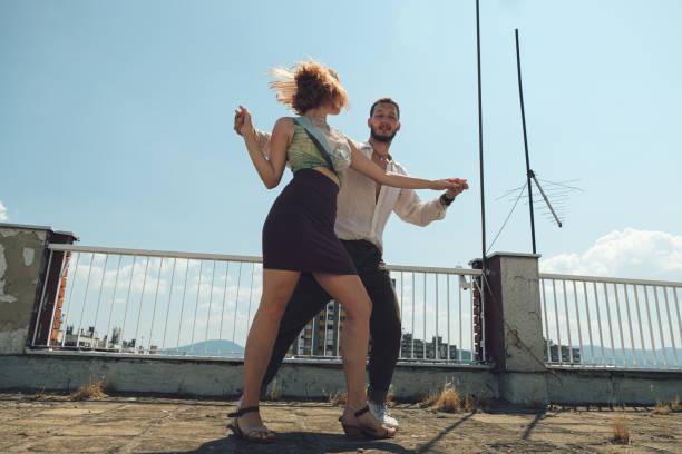 istock Young dancing couple dancing on the rooftop of a building 1336253211