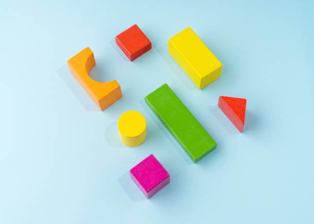 istock Colorful wooden block toy on light blue background. 1336253222