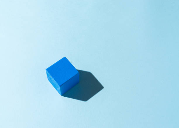 istock Blue wooden cube with a shadow on light blue background. 1336253314