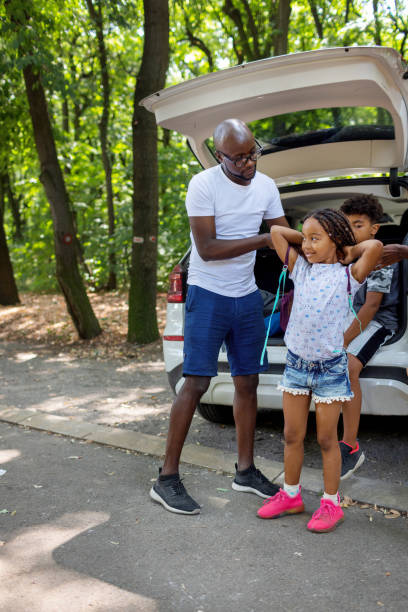 istock Young African Family Getting Ready For Hiking From Car 1336253942