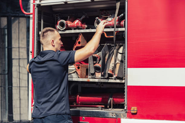 istock Firefighter standing by truck with special equipment 1336255301
