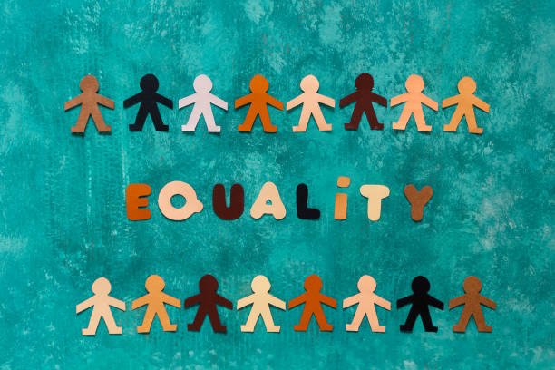 istock The word Equality accompanied by two multi-ethnic paper dolls chains 1336260352