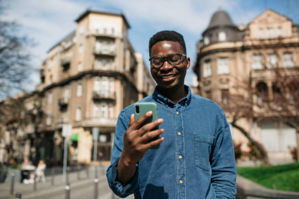 istock Young African American man using a smart phone to call for an Uber 1336262156