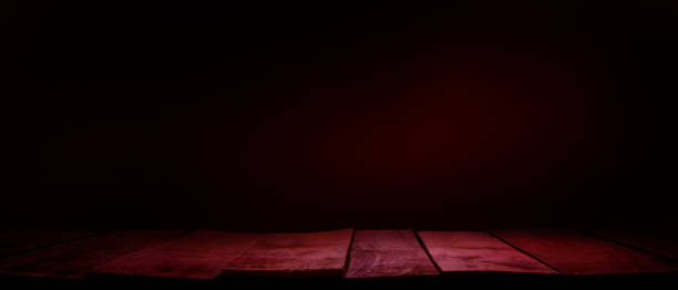 istock A rustic wood tabletop product display background with copy space and a spooky night red tint. 1336262178