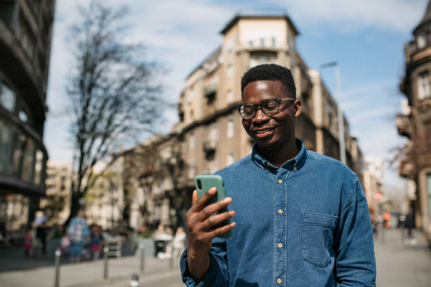 istock Young African American man using a smart phone to call for an Uber 1336262337