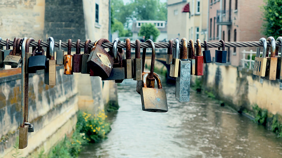 Many locks chained close-up. Symbol of love.
