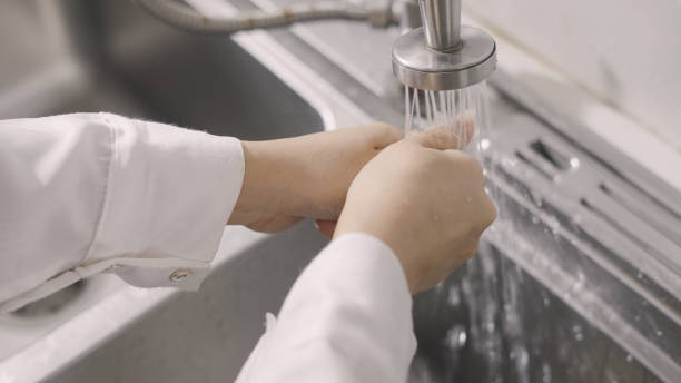 istock Hands being washed at a faucet 1336263831