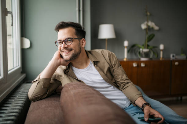 istock Happy young Caucasian man at home, using a smart phone 1336263855