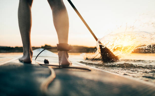 istock Close up of man paddling SUP board 1336264974