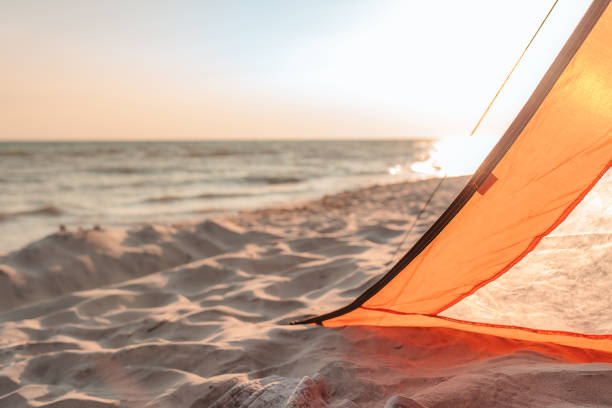 istock relaxation at sunset in tent by sea 1336265635