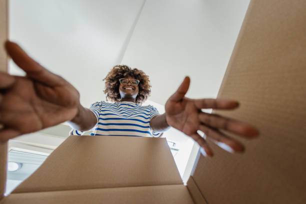 Smiling woman unpacking things out of box