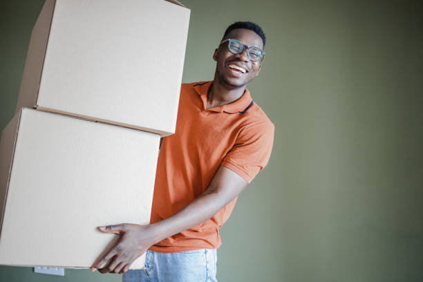 istock African-American man holding carboard boxes 1336269860